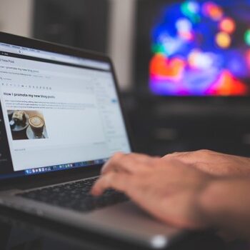 Image of person typing a blog on a laptop using wordpress