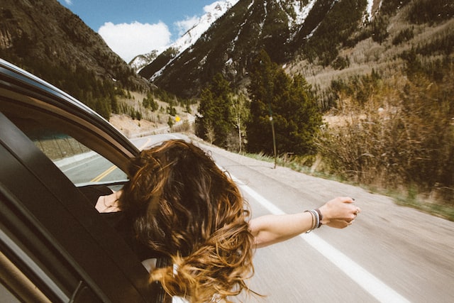 roadtrip woman hanging out window