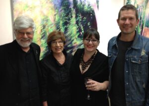 mage of Artist at Birght Places Exhibion Amanda van Gils, Hobie Porter, Lorraine Pilgrim, Seth Pilgrim in front of painting by Amanda