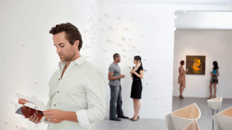 art buyer in gallery looking at catalogue